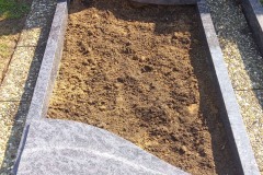 Alfhausen, Grabstein mit Ornament, Laterne, Versenkvase, Teilabdeckplatten und Einfassung